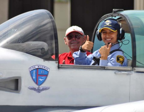 Cadet thumbs up cockpit w plane Midway logo